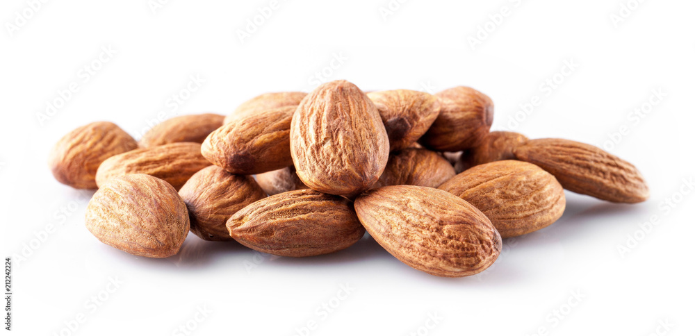 whole almond kernels lie a handful on a white background whole almond kernels lie a handful on a white background