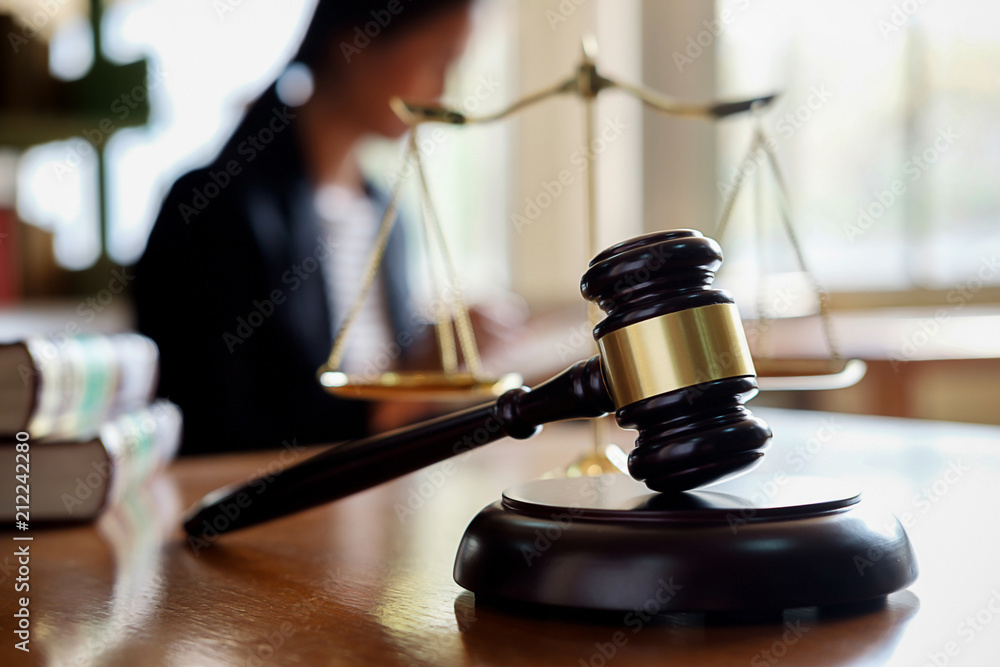 Judge gavel with Justice lawyers having team meeting at law firm in background. Concepts of law. Judge gavel with Justice lawyers having team meeting at law firm in background. Concepts of law.