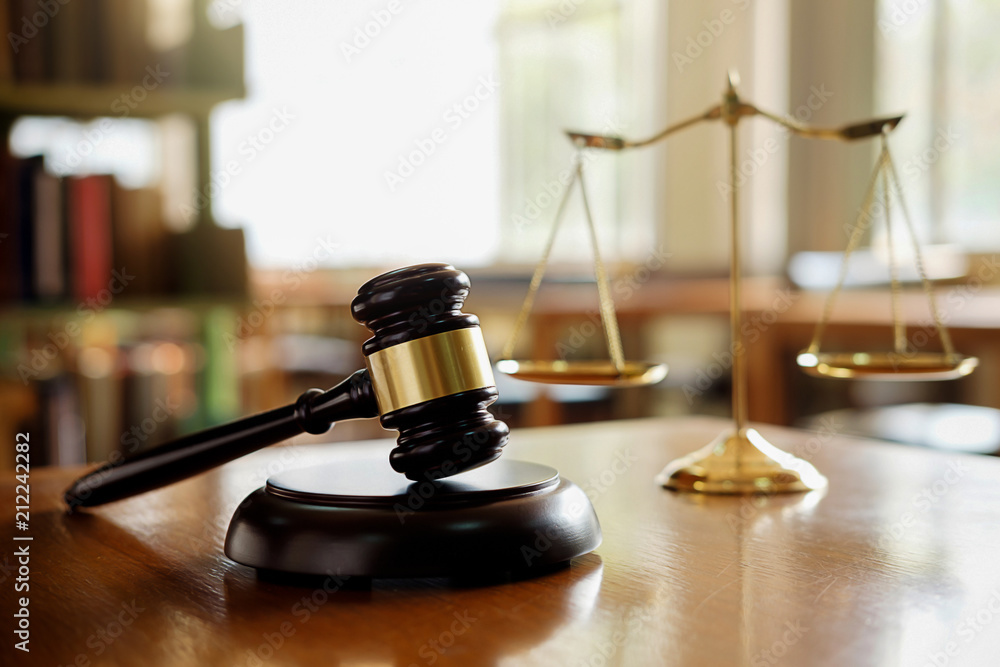 Judge gavel with Justice lawyers having team meeting at law firm in background. Concepts of law. Judge gavel with Justice lawyers having team meeting at law firm in background. Concepts of law.
