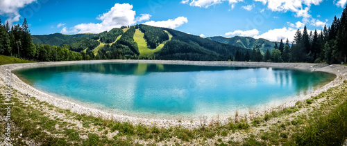 Beautiful mountain landscape with view of lake Speicherteich in the Alps of Austria on sunny summer day.