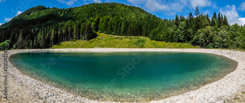 Beautiful mountain landscape with view of lake Speicherteich in the Alps of Austria on sunny summer day.