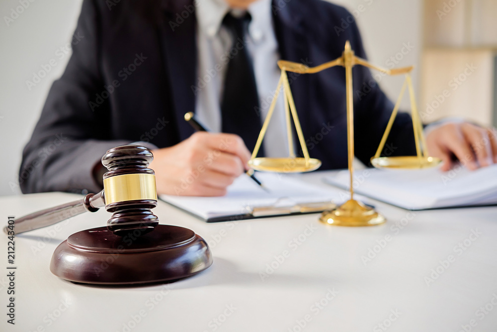 Judge gavel with Justice lawyers having team meeting at law firm in background. Concepts of law. Judge gavel with Justice lawyers having team meeting at law firm in background. Concepts of law.