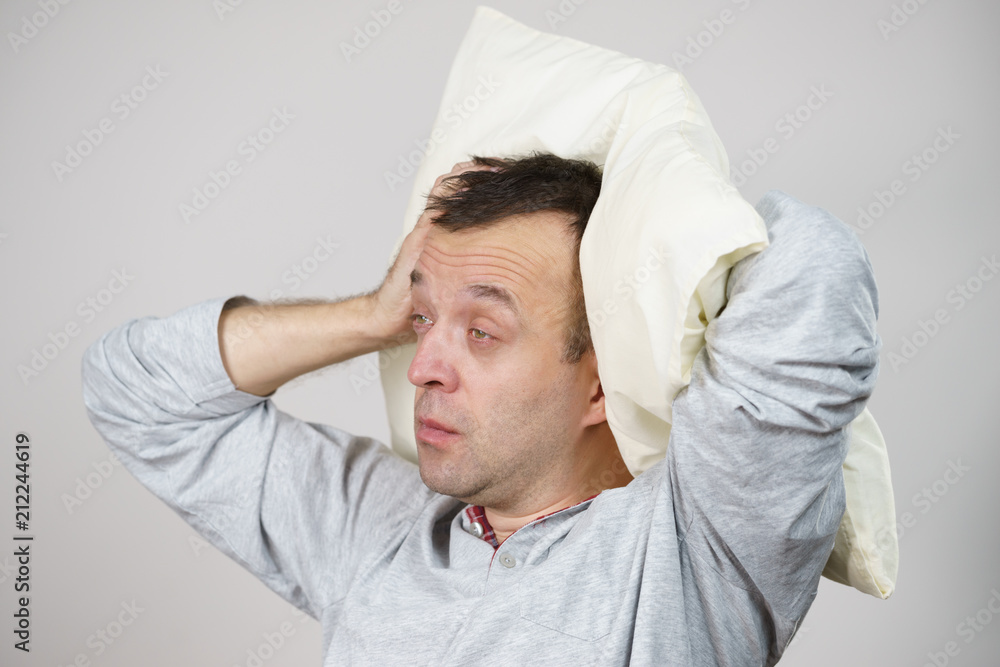 Man sleepy tired with pillow on grey Man sleepy tired with pillow on grey