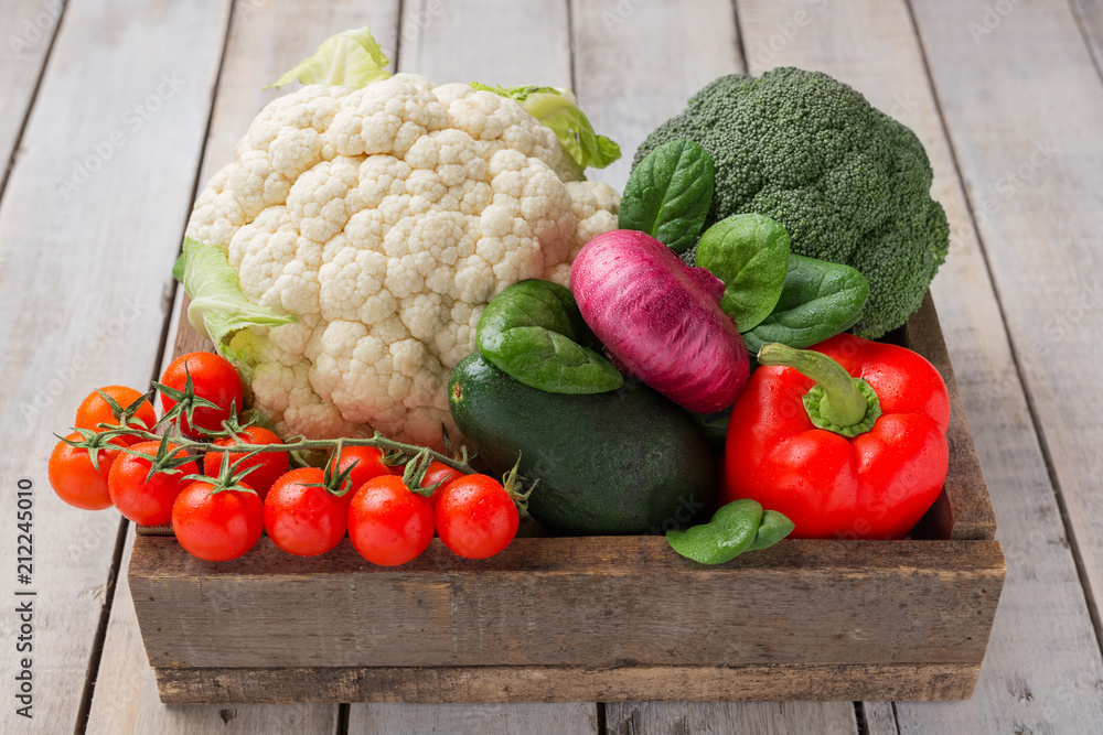 Wooden box of fresh vegetables on wooden background Wooden box of fresh vegetables on wooden background