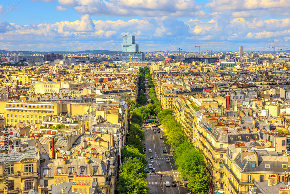 Aerial view of Paris skyline from Arc de Triomphe in a beautiful sunny day with blue sky. Avenue de Wagram from Triumphal Arch. Paris Capital of France in Europe. Scenic urban cityscape.