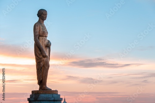 One of the statues glowing in the gold during sunrise at Palais de Chaillot, just in front of Jardins du Trocadero, Paris, France. Palais de Chaillot is a popular spot for watching Eiffel Tower.