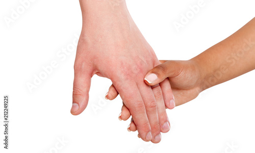 Holding hands couple of a mixed race on white background. photo