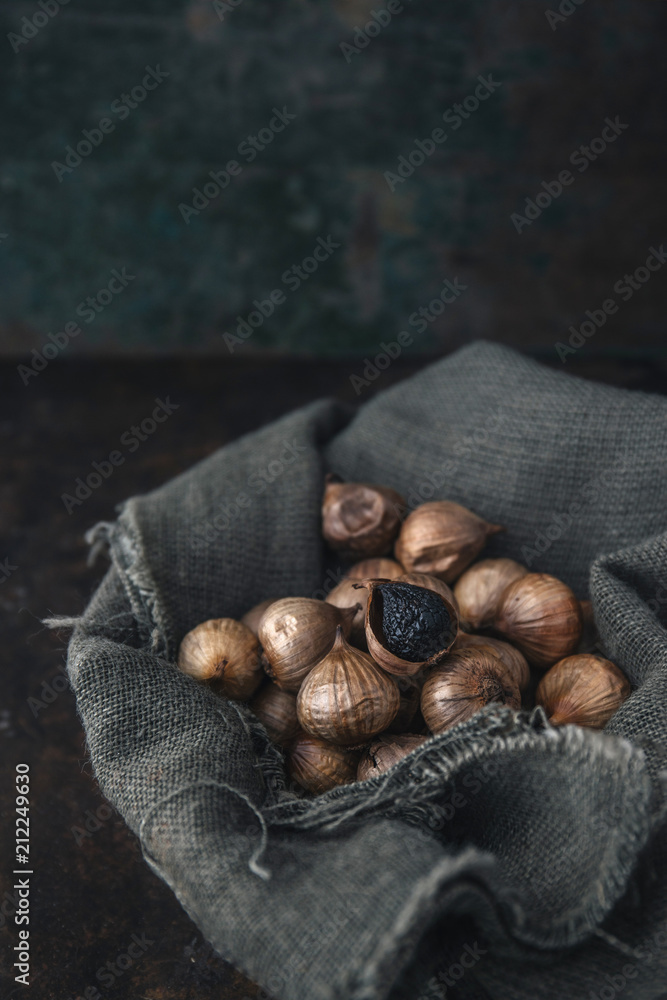 Obraz premium Black garlic with rustic background