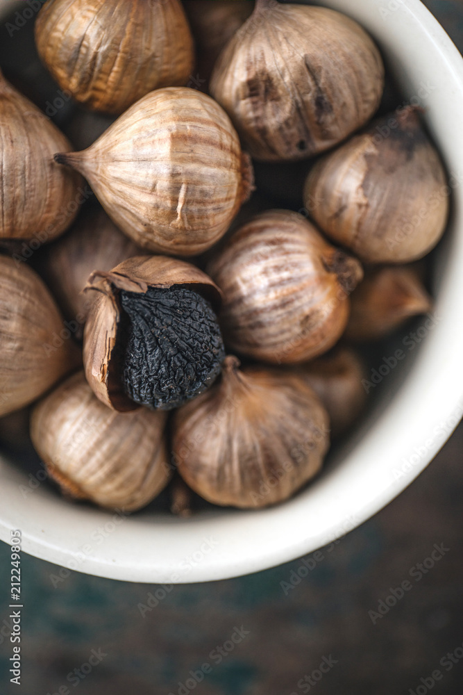 Black garlic with rustic background