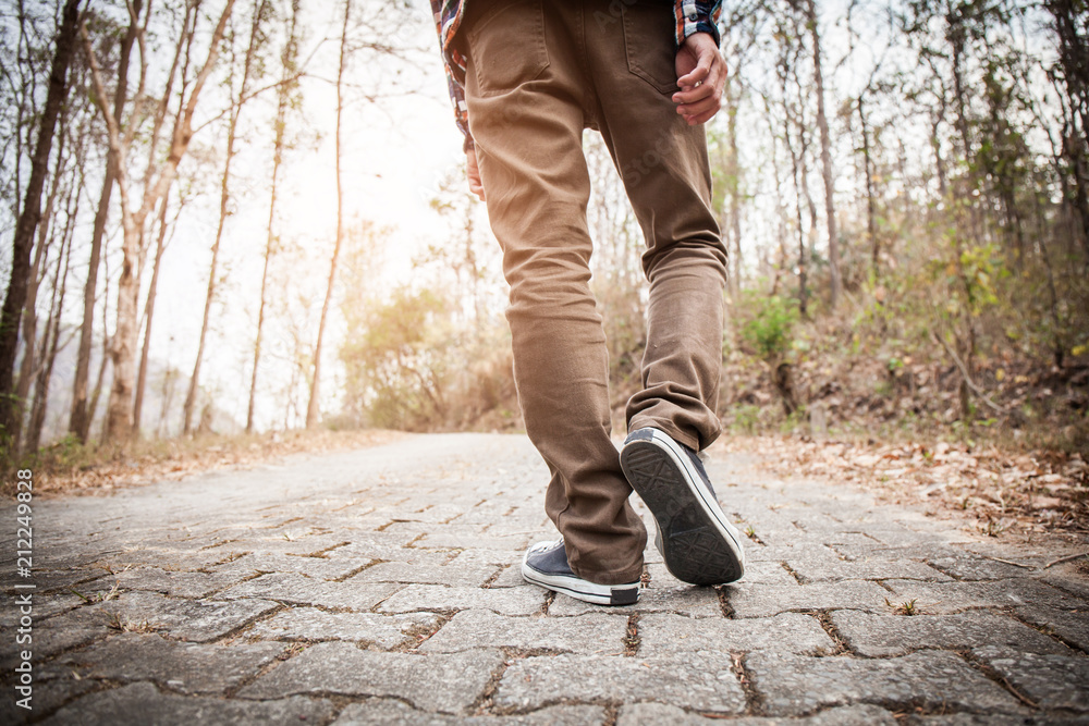 Men wear sneakers and walk on the street. Men wear sneakers and walk on the street.