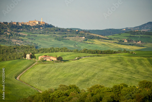 Pienza: Chapel of the Madonna di Vitaleta with the city of Pienza in the background. Siena, Tuscany, Italy.