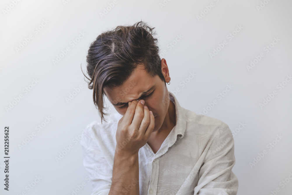 Young man has headache, isolated on white background Young man has headache, isolated on white background