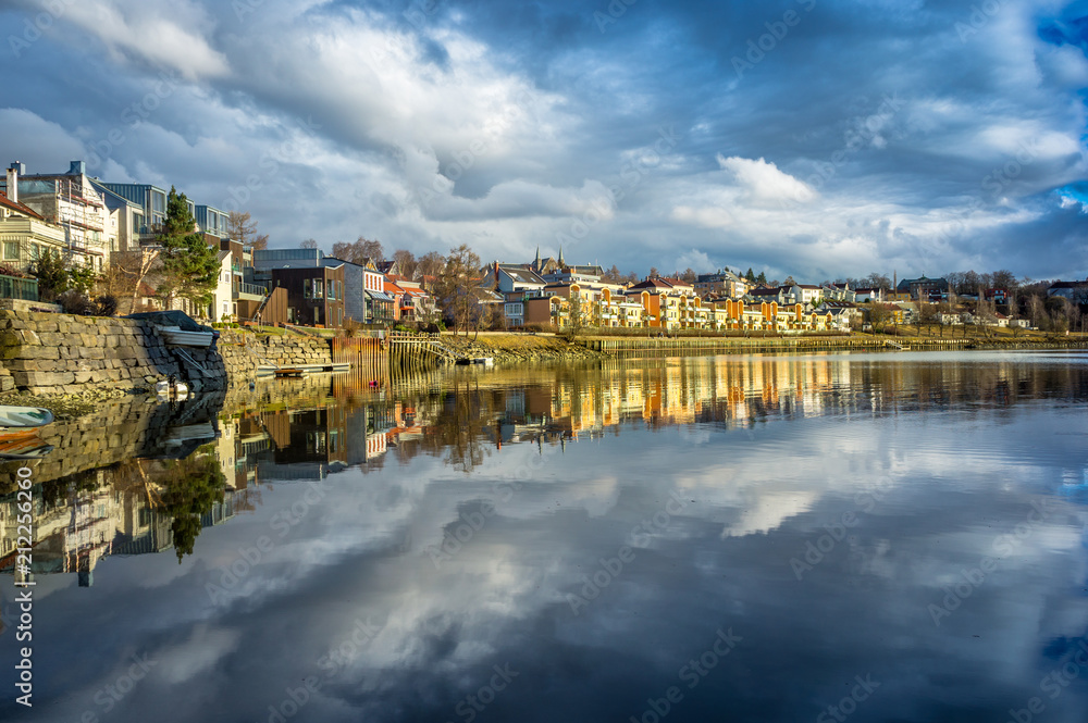A view of Trondheim reflected in the river. Sunset before the storm. Norway