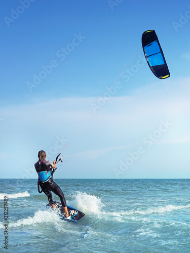 Woman on board on wave kiting in the ocean