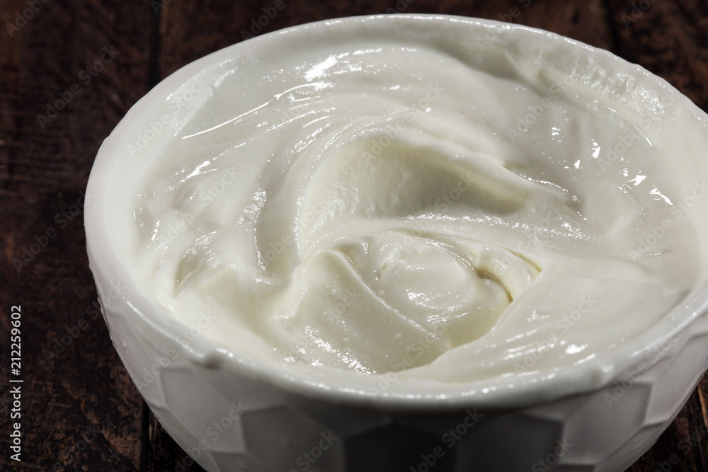 close up of a white whipped or sour cream in bowl. close up of a white whipped or sour cream in bowl.
