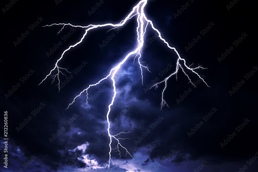 A Lightning Strike On A Cloudy Dramatic Stormy Sky Stock Photo