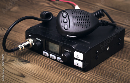 Fotografie cb Radio transmitter isolated on wooden table background.