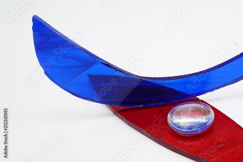 Red and blue glass pieces on white background
