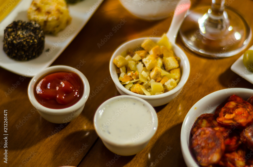 Set with different appetizers in small portions, healthy and delicious snacks Set with different appetizers in small portions, healthy and delicious snacks