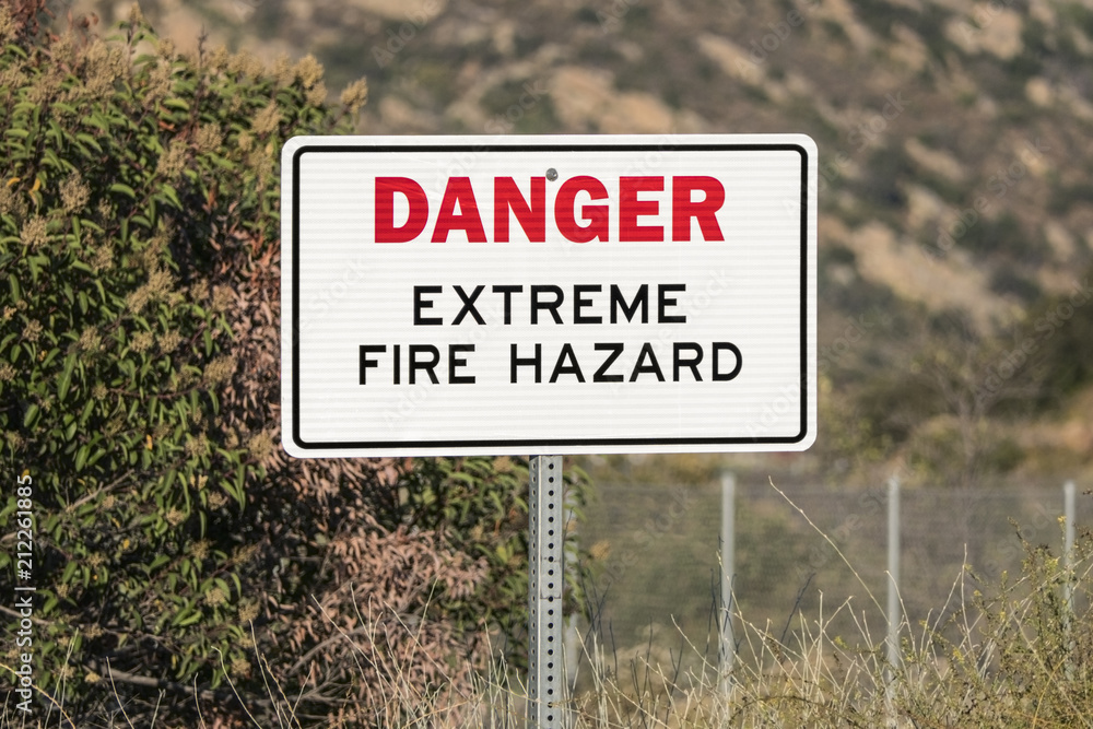 Danger extreme fire hazard sign in dry brush mountain canyon. Danger extreme fire hazard sign in dry brush mountain canyon.
