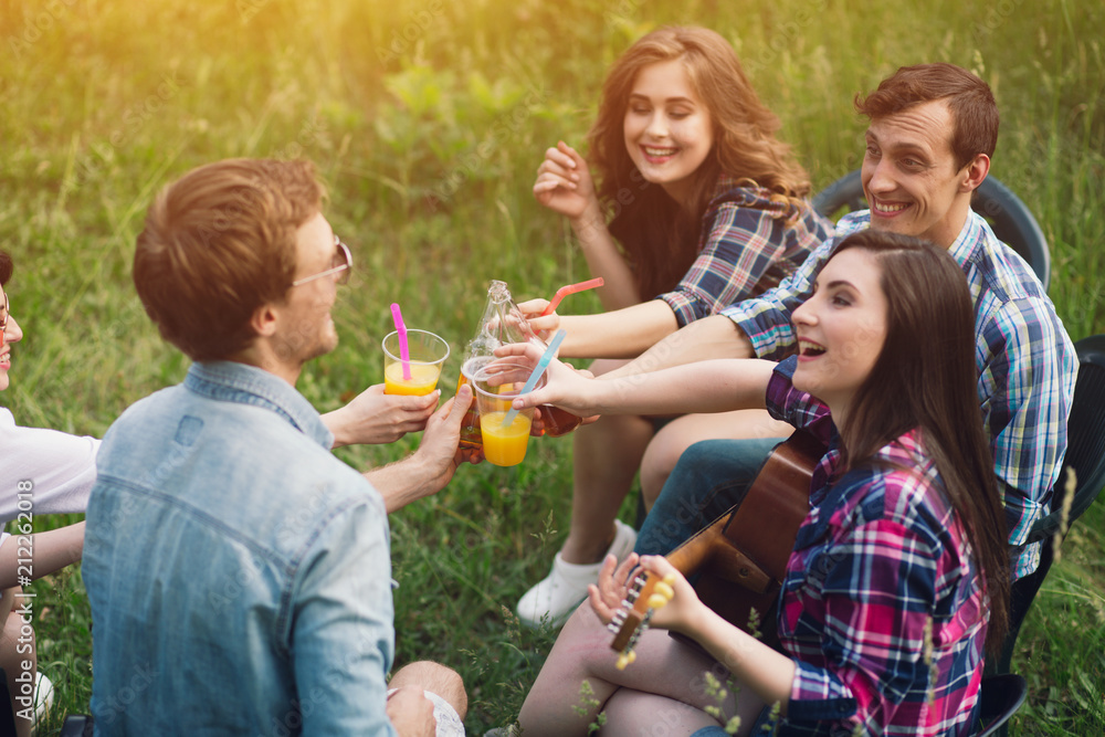Group of friends hanging out in park. Cheerful group of young people  chilling together outdoors on grass with beverages. Stock Photo | Adobe  Stock