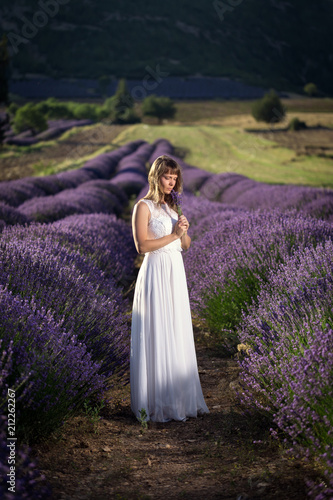 Young woman in a white dress in a lavender field