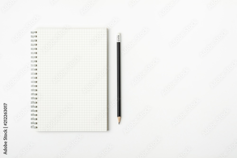 grid paper book and pencil on a white desk - for business concept background grid paper book and pencil on a white desk - for business concept background