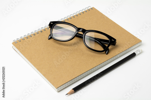 glasses, pencil on a notebook - for business concept background