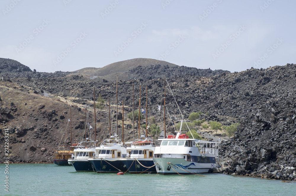 ooden ships on port of Nea Kameni volcanic island near Santorini ooden ships on port of Nea Kameni volcanic island near Santorini