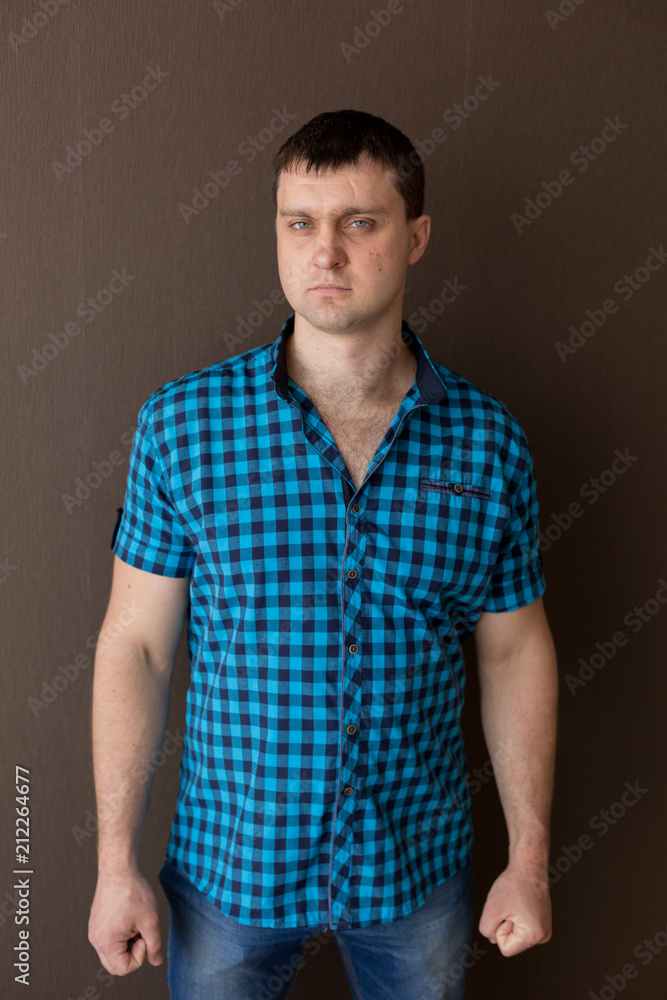 young man. the man in the shirt in the cage. portrait of a man young man. the man in the shirt in the cage. portrait of a man