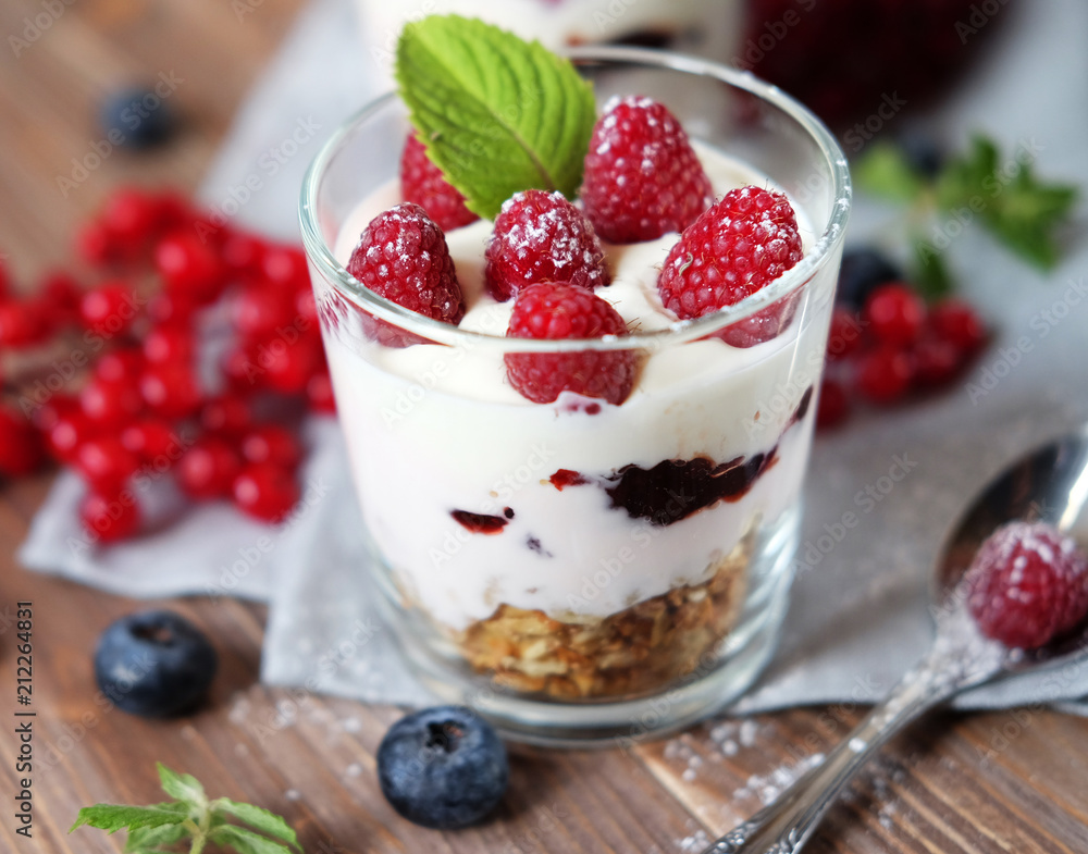 healthy eating and diet concept: Happy breakfast - yogurt with muesli and berries on a wooden table healthy eating and diet concept: Happy breakfast - yogurt with muesli and berries on a wooden table