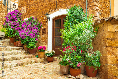 Fototapeta Naklejka Na Ścianę i Meble -  Beautiful flowers street in old village of Fornalutx on Mallorca island, Spain