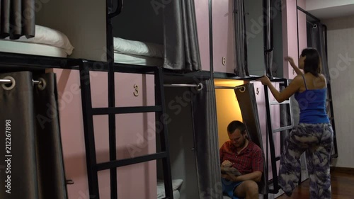 Man and woman in a capsule hotel photo