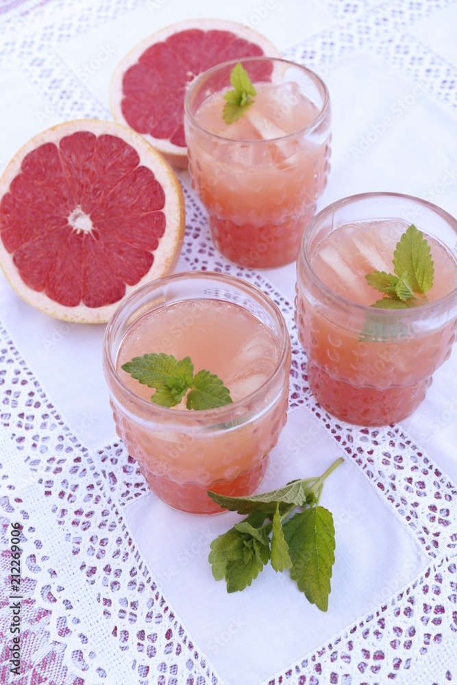 Pink grapefruit juice and mint in glasses Pink grapefruit juice and mint in glasses