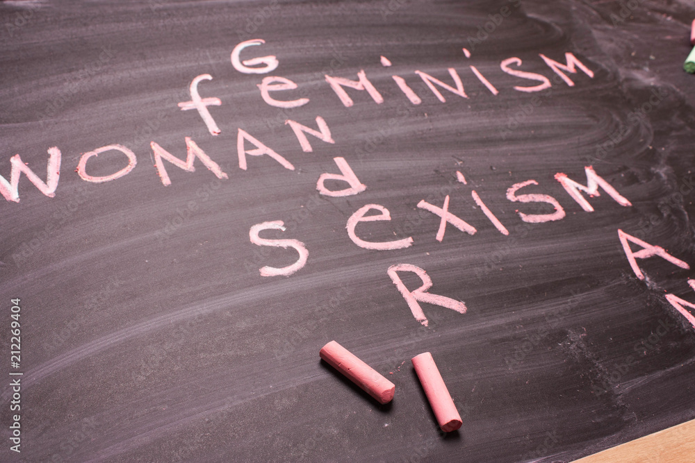 Fototapeta premium Words gender, sexism, feminism written in pink chalk