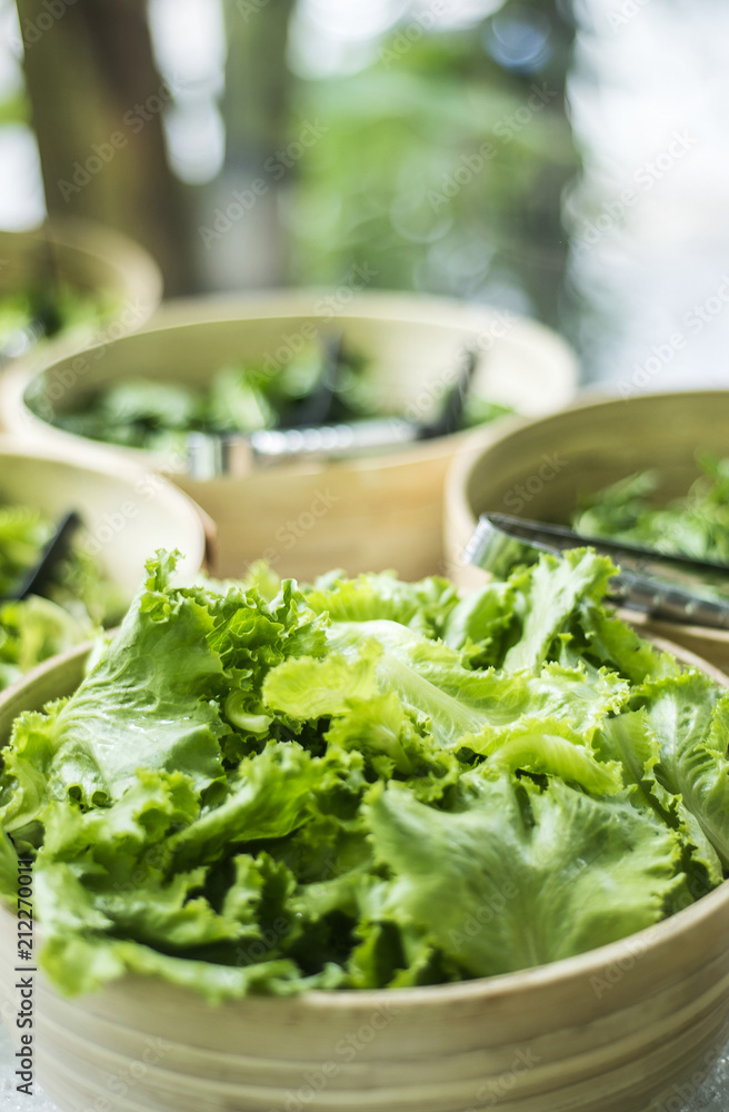 bowls of fresh organic lettuce leaves in salad bar display bowls of fresh organic lettuce leaves in salad bar display