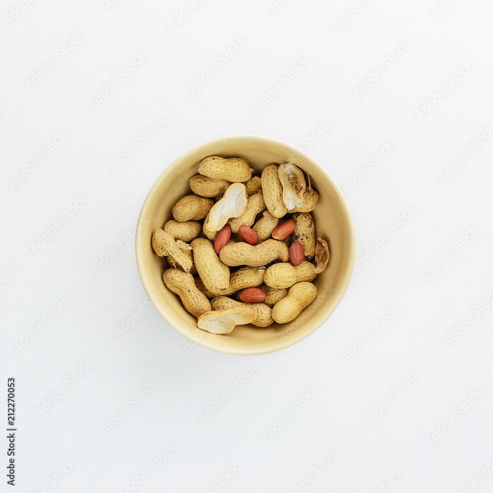 Cup with peanuts on white background Cup with peanuts on white background