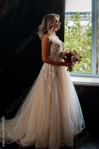 Beauty portrait. Beautiful young woman with perfect makeup and hairstyle i on black background. Glamour bridal look with crystal earrings and hair accessories. photo