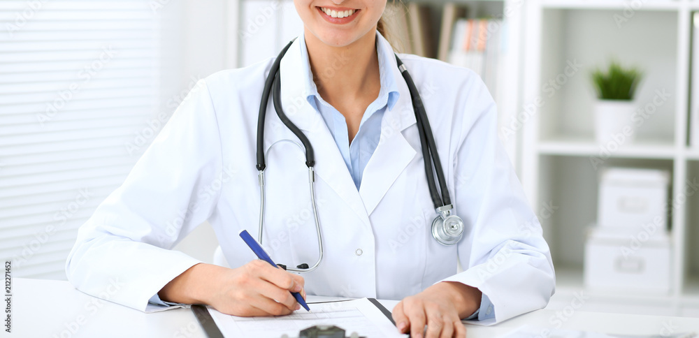 Doctor woman working at hospital. Closeup of stethoscope. Health care, insurance and help concept Doctor woman working at hospital. Closeup of stethoscope. Health care, insurance and help concept