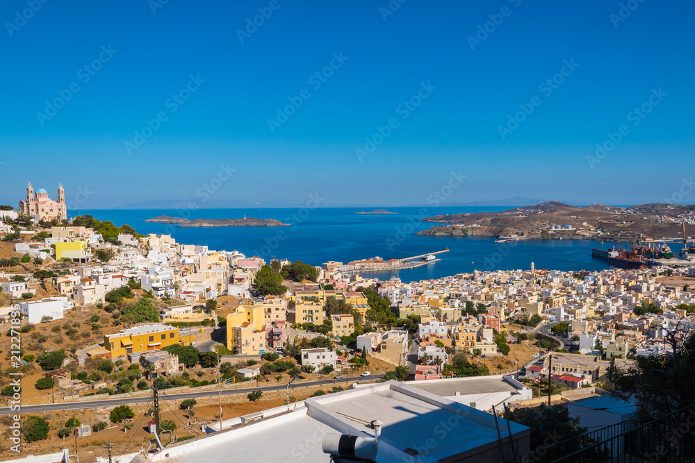 Panoramic view of Ermoupoli city of Syros Island in Cyclades, Greece. Top view of the colorful houses, the port and the  Orthodox Anastaseos church
