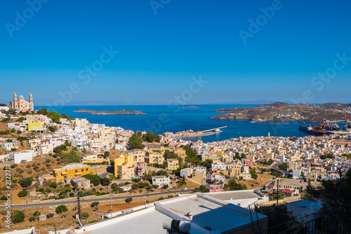 Panoramic view of Ermoupoli city of Syros Island in Cyclades, Greece. Top view of the colorful houses, the port and the Orthodox Anastaseos church