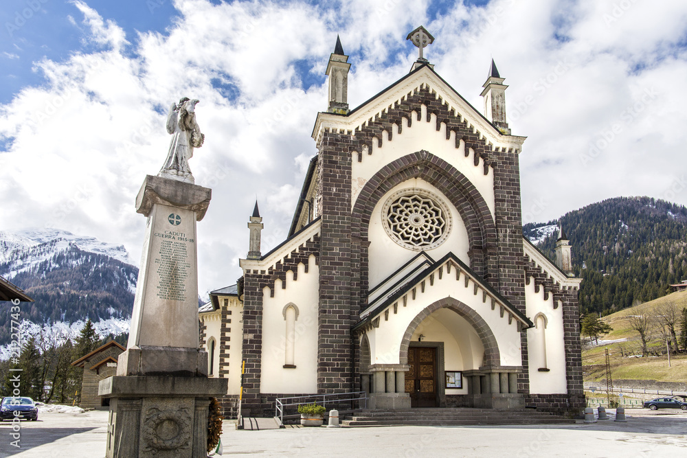 Falcade, Italy- 5 April 2018: The church of the Blessed Virgin Immaculate was founded on January 20, 1866. Falcade village, Belluno, Italy. Church of Falcade, Dolomites, Italy.