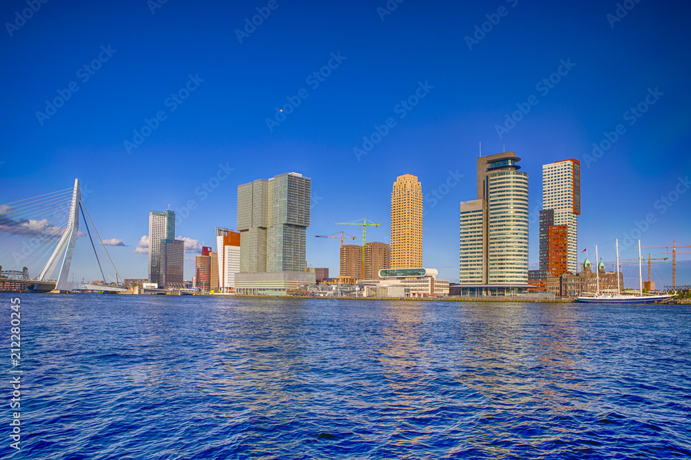 Obraz premium Travel Destinations. Cityscape View of Rotterdam Harbour and Port in Front of Erasmusbrug (Swan Bridge) on Background.