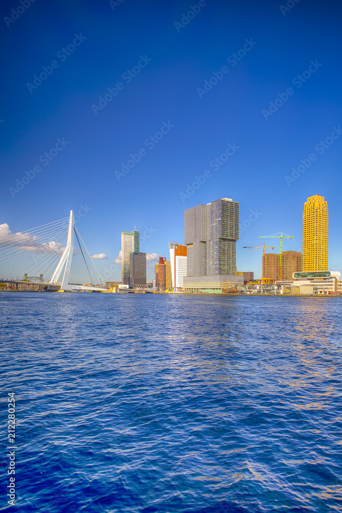 Travel Destinations. Cityscape View of Rotterdam Harbour and Port in Front of Erasmusbrug (Swan Bridge) on Background.