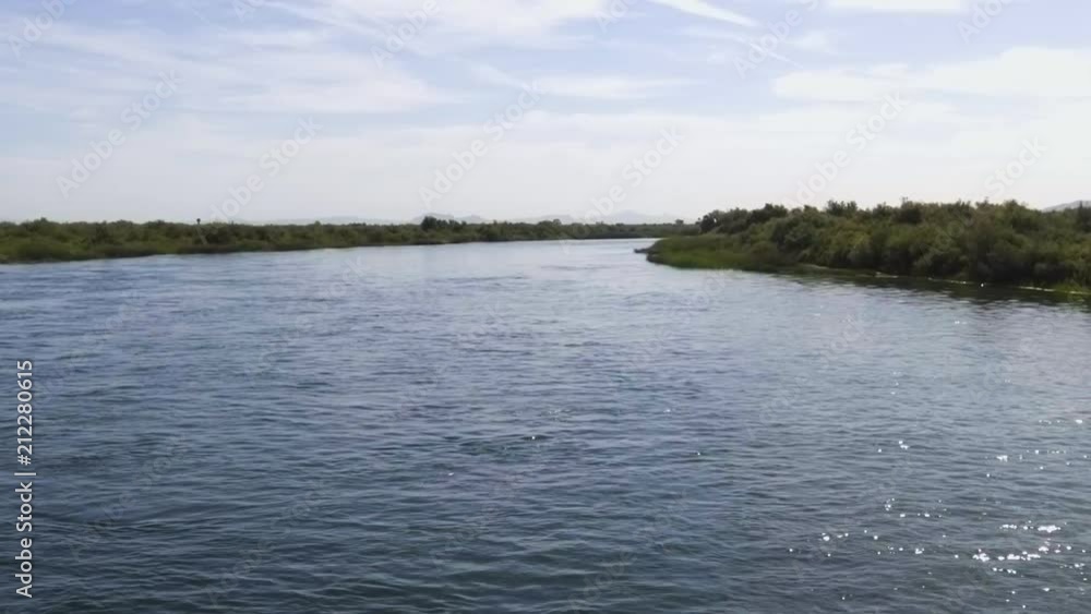 The deep blue Colorado river flowing mid summer The deep blue Colorado river flowing mid summer
