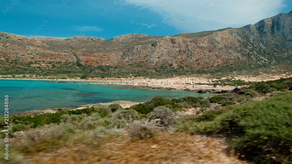 Tracking shot along the beautiful rugged coast of Balos beach in Crete, Greece, featuring prominent turquoise waters Tracking shot along the beautiful rugged coast of Balos beach in Crete, Greece, featuring prominent turquoise waters