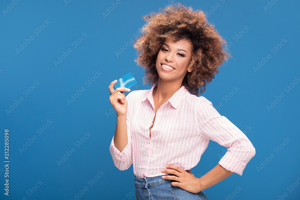 African american woman holding credit card in hand. African american woman holding credit card in hand.