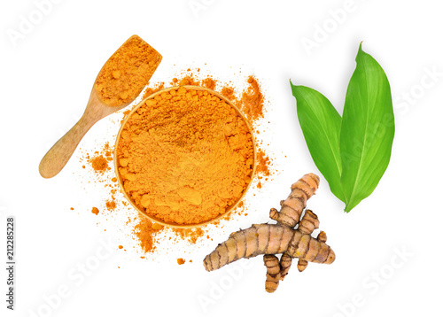 turmeric root and turmeric powder in wooden bowl and spoon with green leaves isolated on white background,flat lay,top view