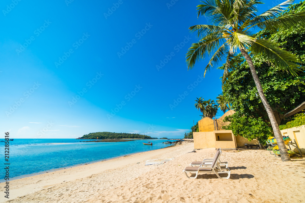Beautiful tropical beach and sea with chair on blue sky