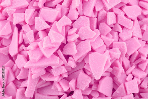 Candy background, copy space. Closeup of pile pastel chocolate candies. Candy texture. Food pattern. Sweets background. Pink abstract background. Top view, flat lay